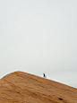 person running on top on hill during daytime