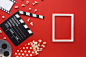 Top view cinema elements on red background with white frame