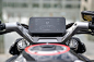 This may contain: an electronic device mounted on the handlebars of a motorcycle