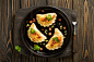 Fried dumplings with onion and bacon top view by Kamil Zabłocki