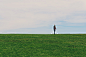 person standing on green grass field