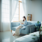 ls7623_An_Asian_woman_sitting_on_a_sofa_reading_a_bookBlack_sha_792d4252-a267-4d98-becf-c24dc1b04d97