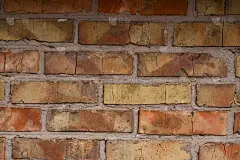 旧的橙色砖墙图案。砖的背景。好的壁纸。旧墙的库存照片。