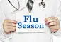 Doctor holding a card with Flu Season, medical concept