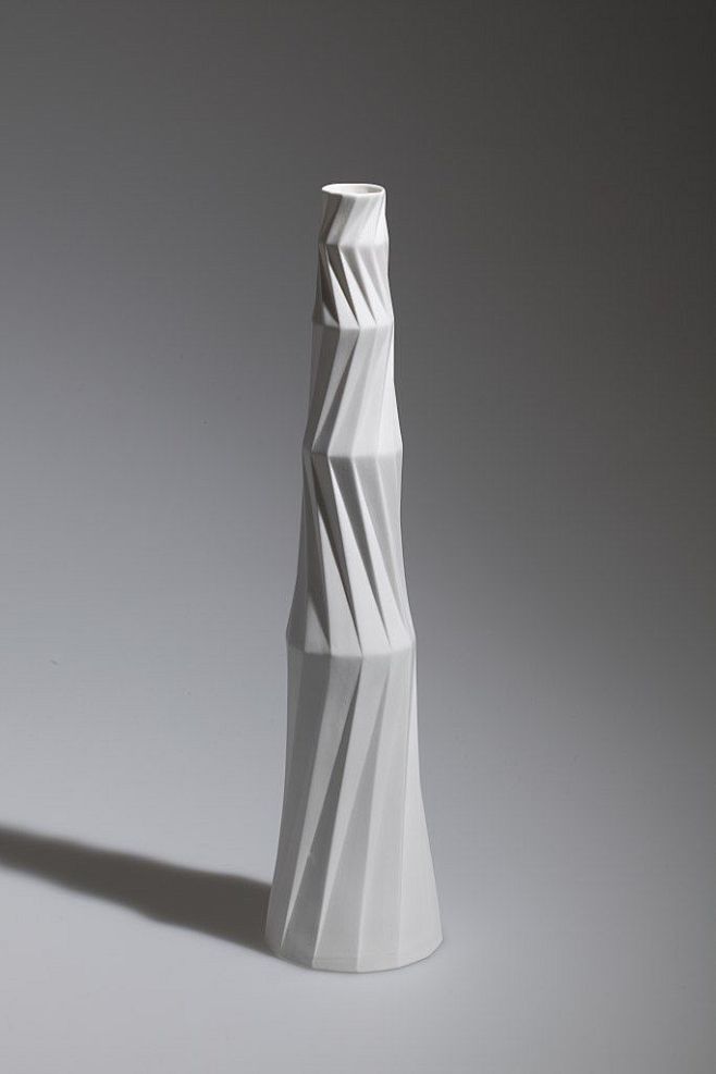 a white vase sitting...