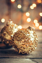 Golden christmas ornaments on rustic background