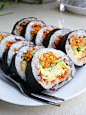 紫菜包饭的做法
主料
米饭 (适量)
辅料
红豆馅 (适量) ,鸡蛋 (适量) ,黄瓜 (适量) ,胡萝卜 (适量)
厨具
平底锅
1材料：米饭，红豆馅，鸡蛋，黄瓜，胡萝卜，韩式辣酱，海苔，寿司帘。
 2鸡蛋打散，备用。
 3平底锅里放入油，烧热。把鸡蛋液倒入，均匀的摊成鸡蛋皮。
 4把胡萝卜，黄瓜和鸡蛋皮切成丝备用。
5把红豆馅拌入米饭，用一半红豆馅，一半的白米饭。
6拿出一张海苔，铺在寿司帘上。
7把米饭铺在海苔上。
8放上韩式辣酱和胡萝卜黄瓜鸡蛋丝。
9用寿司帘卷起，来回卷几次捏紧。
10用刀切