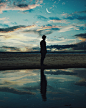 Silhouette of Man Standing Near Body of Water