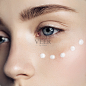 Beautiful woman with cream dots on the face