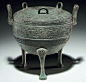 Lot 1130. A BRONZE RITUAL TRIPOD FOOD VESSEL AND COVER, DING WARRING STATES PERIOD, 5TH CENTURY BC (The Bronze ding is illustrated the pottery ding is not) Bronze ding 10 in. (25.4 cm.) high; pottery ding 10 in. (25.4 cm.) high (2) Estimate: $25,000-35,00