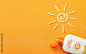 Sunscreen on orange background. Plastic bottle of sun protection and white sun-shaped cream 素材庫相片