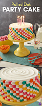 Decorate your cake with high contrast, saturated colors using the "pulled dot" technique. Pipe vertical rows of dots and using a spatula, "pull" your dots. The simple pulled dot gets an updated edge when you switch colors as you pipe.