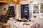 Christmas meal laid on table in decorated dining room.