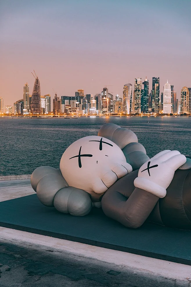 KAWS debuts inflatable sculpture on doha's dhow harbor overlooking the ...