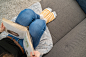 woman lying on sofa while reading a book