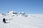 people riding snowmobiles at the field during day