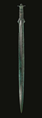 A EUROPEAN BRONZE SWORD  SOUTH-CENTRAL EUROPE, BRONZE AGE, CIRCA 12TH-10TH CENTURY B.C.   The lanceolate blade inserted into the separately-cast hilt, the blade with a peaked midrib, the edges serrated toward the hilt, lentoid in section, the baluster-sha