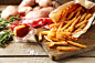Tasty french fries on cutting board, on wooden table background :: Stock Photography Agency :: Pixel-Shot Studio