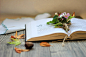 Open book with autumn flowers on the table by Vera Kandybovich on 500px