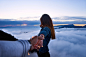 person holding woman's hand on top of hill