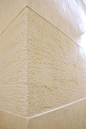 Travertine and smooth polished plaster texture applied in bands creates interest and definition.