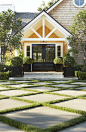 This expansive front yard has five gardens, each with its own look. For this area, Shrader interspersed concrete squares with grass and planted a small patch of lawn alongside the pattern. “Rather than just laying down sod, pick the right spot to use gras