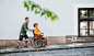 残疾人用假肢推着轮椅上的朋友，友谊的概念。图片素材