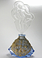 This 1920-30s era Czech perfume is unusual in that there are no jewels set in the heavy ornate filigree that completely encases the blue cut glass base.