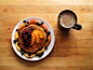 whole wheat pancakes topped with earth balance, sliced peaches, thawed mixed berries, blueberries, and maple syrup, coffee with soy milk