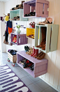 Such a great entryway, colorful crates hung on the wall for shoe storage | 100+ Beautiful Mudrooms and Entryways at Remodelaholic.com