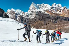 Adventurous People making Ascent to high Mountain walking on Glacier