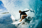 man in black wet suit surfing on water during daytime