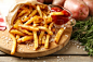 Tasty french fries on cutting board, on wooden table background :: Stock Photography Agency :: Pixel-Shot Studio