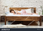 Woman sleeping on a white pillow and a mattress on a wooden bed. Concept of comfortable sleep. orthopedic mattress and pillow