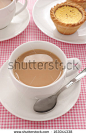 Tea served with milk in a white tea service - stock photo