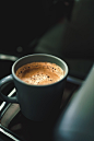 black ceramic mug with brown liquid inside