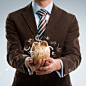 Kirill Kedrinski在 500px 上的照片Business man holding piggy bank, currency symbols flying around 