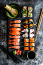 Sushi and sashimi variety on rustic background by Alena Haurylik on 500px