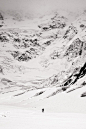 “Traversing beneath the immense and avalanche-prone 3000m high north face of Pik Pobeda (7439m, Tien Shan, Kyrgyzstan). Taken on the way to remote Pik Pobeda East (6762m), prior to making the first ski descent.” — August 2010