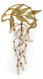 An Art Nouveau enamel, pearl and gold brooch, attributed to Henri Vever, circa 1900. Articulated brooch with plique-à-jour enamel foliage and dogtooth pearl wisteria blossoms, possibly after a design by René Lalique. French eagle mark for 18k, no maker ma