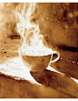 This may contain: a coffee cup with steam coming out of it