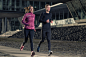 Active young couple jogging in an urban street