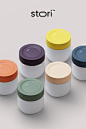several containers with lids are shown in different colors