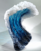 a blue and white wave sculpture sitting on top of a table