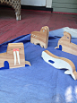 Arctic Playset : Wooden box containing a set of Arctic animal toys: a walrus, a beluga whale, a polar bear, a stellar sea lion, a sea otter, a puffin, plus a fish for them to fight over. Simple wooden toys work as blocks or as toys for narrative play, whi