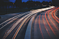 White and red light trails on a highway in the evening