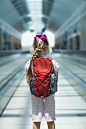 Caucasian girl riding on airport moving walkway - Caucasian girl riding on airport moving walkway: 