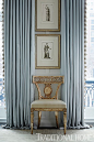 Elegant blue draperies frame an pretty side chair and stacked artwork. - Photo: Werner Straube / Design: Gail Plechaty: