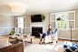 Living room - large transitional enclosed light wood floor living room idea in Philadelphia with gray walls, a standard fireplace, a stone fireplace and a wall-mounted tv