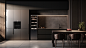 yyhxm5_a_black_kitchen_with_a_stainless_steel_refrigerator_in_t_29fe0535-55c7-4b71-8b6f-228e77f78c25